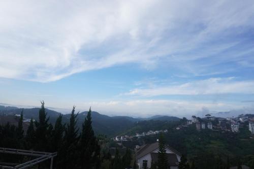 a view of a city with mountains in the distance at Famille Hotel - Central hotel in Dalat in Xuan An