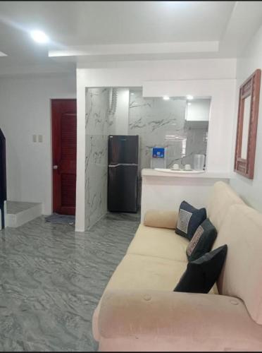 a living room with a couch and a kitchen at elisatransienthouse in Labac