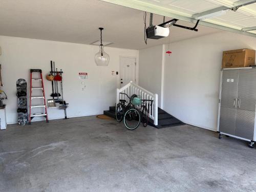 an empty garage with a bike parked in it at Fun & Comfort for 8 in Roger! King & Arcade Games in Rogers
