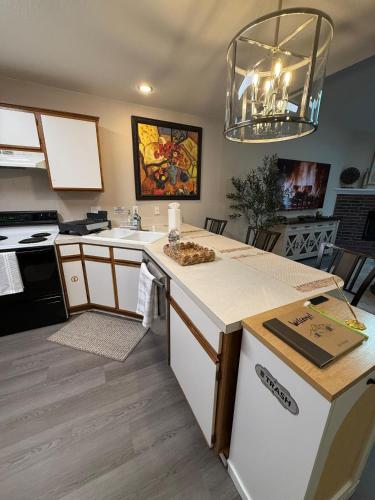 a kitchen with a sink and a counter top at Fun & Comfort for 8 in Roger! King & Arcade Games in Rogers