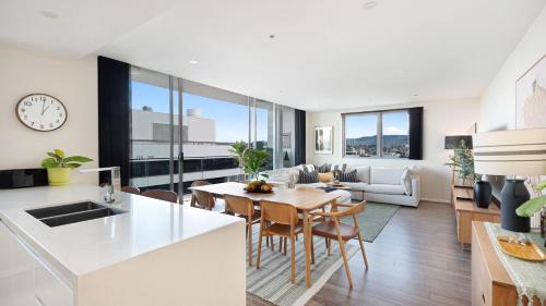 a kitchen and living room with a table and chairs at Burelli Beauty in Wollongong