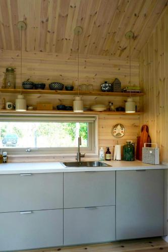 a kitchen with a sink and a window at Cosy Guest House At Ekstakusten in Fröjel