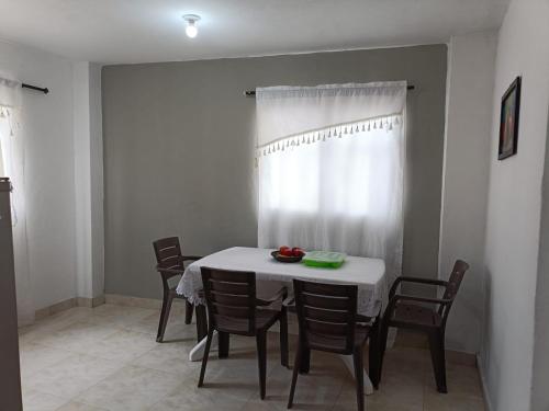 a dining room with a white table and chairs at Apto Gaira La Dulce in Gaira