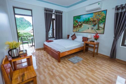a bedroom with a bed and a large window at Phong Nha Cherish Homestay in Bố Trạch