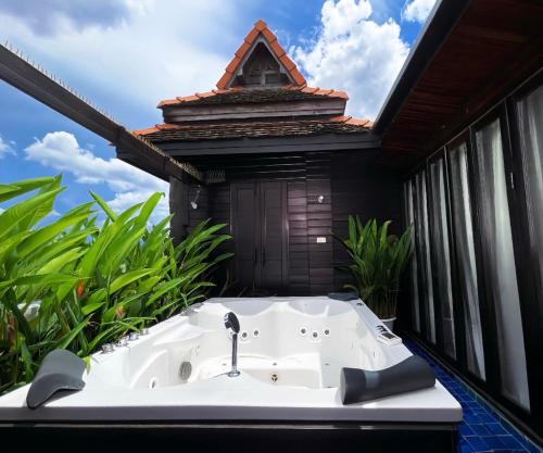 a bath tub sitting in the middle of a balcony at Singha Montra Lanna Boutique Style Hotel in Chiang Mai