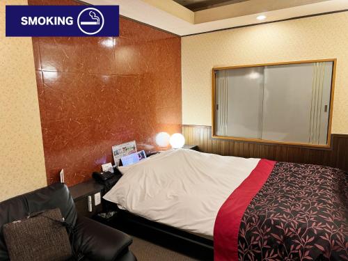 a hotel room with a bed and a window at Restay lagoon in Tokyo