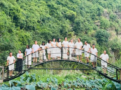 a group of people standing on a bridge at Green Valley Homestay - Thung Lũng Xanh in Nguyên Ngoại