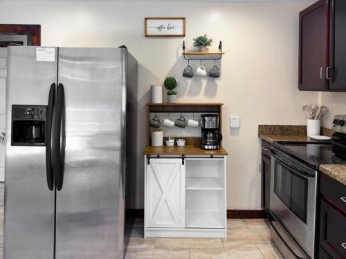 a kitchen with a large stainless steel refrigerator at Lake Huron Getaway by arc Vacation Rentals in Lexington