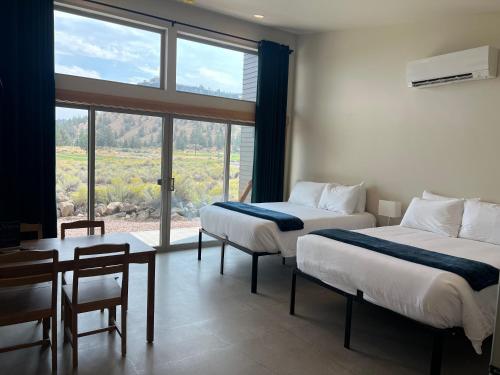 a hotel room with two beds and a window at Crooked River Ranch Cabins in Terrebonne