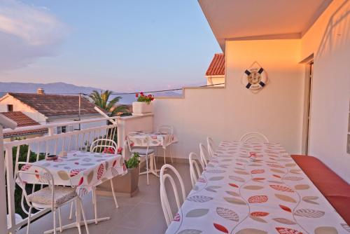 a room with a table and chairs on a balcony at ꕥ ROOMS SUNCE, Family choice, Best Panoramic view, Supetar Island Brac in Supetar