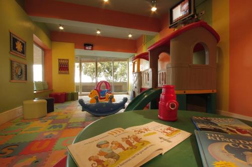 a childs play room with a table and a play area at Taal Vista Hotel in Tagaytay