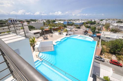 a large swimming pool on top of a building at Phenomenal Location Near Beach & 5th with Stunning Roof Pool in Playa del Carmen