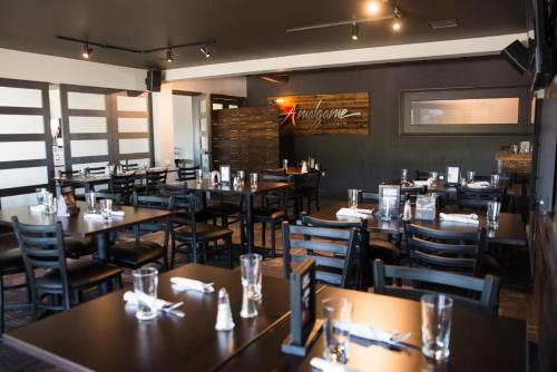 a restaurant dining room with tables and chairs at Hôtel Écono-One in Amos