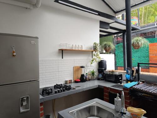 a kitchen with a sink and a stove top oven at Casa Luna Lago Calima in Calima
