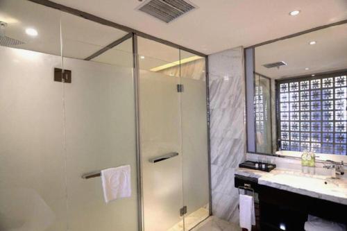 a bathroom with a shower and a sink at Harbin Splendent Hotel in Harbin