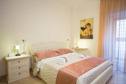 a bedroom with a bed and a dresser and a window at B&B Casa Cavour in San Benedetto del Tronto