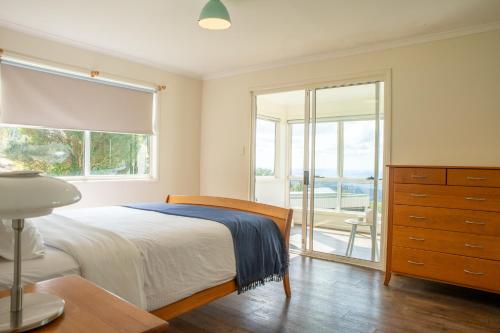 a bedroom with a bed and a large window at Horizon View Cottage in Bald Knob