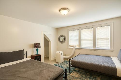 a bedroom with two beds and a window at Spacious 4BR Family Home in Detroit WiFi Parking in Detroit
