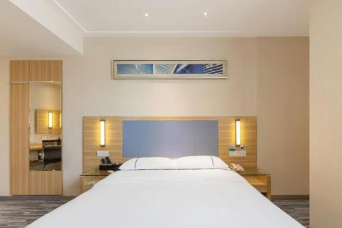 a large white bed in a hotel room at City Comfort Inn Guilin Xiangbi Mountain Park in Guilin
