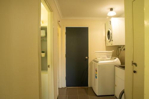 a small kitchen with a refrigerator and a microwave at Horizon View Cottage in Bald Knob