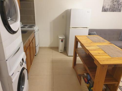 a kitchen with a table and a washer and dryer at Cozy 1 Bedroom in Lowlands