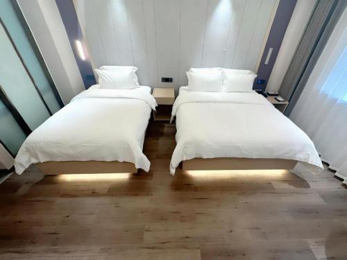 Letto o letti in una camera di Lavande Hotels Jinzhong Youjian Pingyao