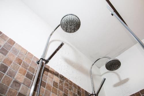 a shower with a shower head in a bathroom at Belmonte Hotel, Dependance Alba Palace Hotel in Favara