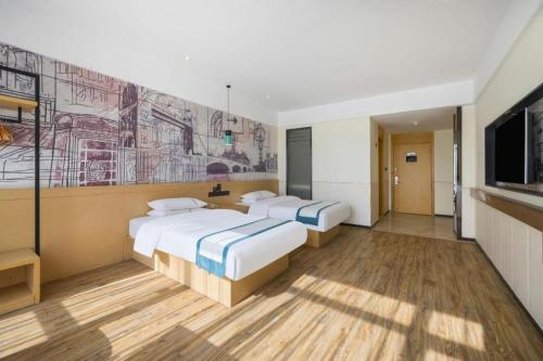 a hotel room with two beds and a tv at City Comfort Inn Changsha South Railyway Station West Square in Changsha