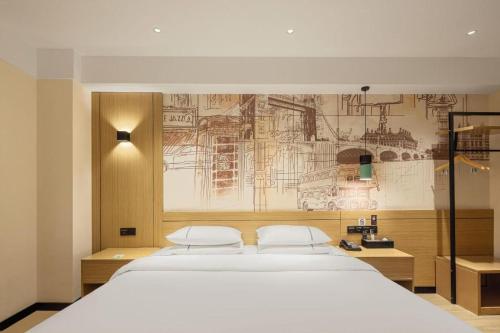 a bedroom with a bed with a drawing on the wall at City Comfort Inn Changsha South Railyway Station West Square in Changsha