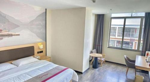 a hotel room with a bed and a large window at Thank Inn Plus Hotel Guangdong Yunfu Luoding City Municipal in Yunfu