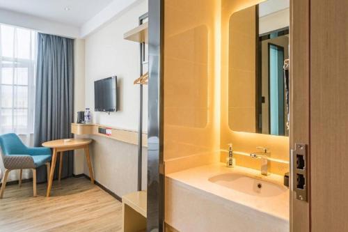 a hotel room with a sink and a mirror at City Comfort Inn Lhasa Potala Palace Scenic View in Lhasa