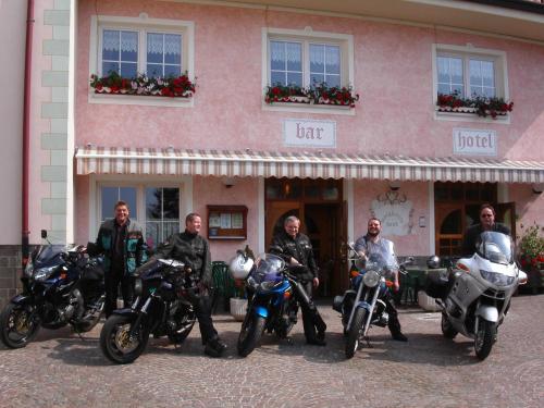 a group of men on motorcycles parked in front of a building at Alpen Garten Hotel Margherita in Rumo