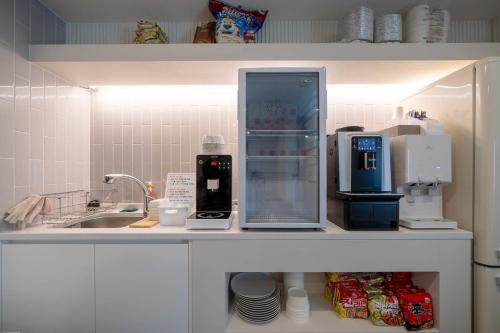a kitchen with a counter top with appliances on it at 그랜디스 호텔 문현 in Busan