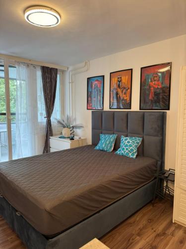 a bedroom with a large bed with blue pillows at Paloma Blanca 2 in Gárdony