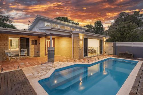 a house with a swimming pool in front of a house at Peaceful Peron - outdoor pool, close to beach in Dunsborough