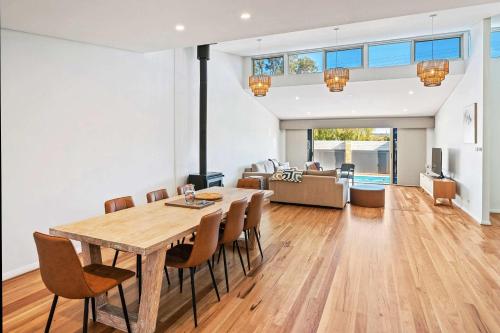 a dining room and living room with a table and chairs at Peaceful Peron - outdoor pool, close to beach in Dunsborough