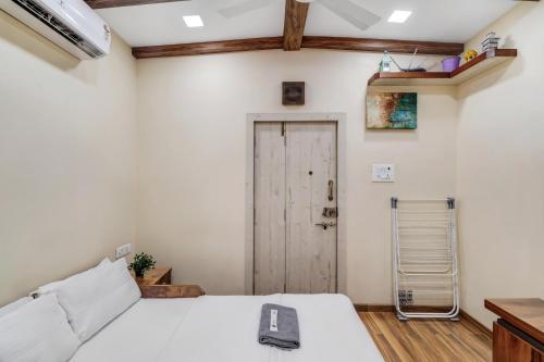 a bedroom with a bed with a phone on it at Pebble Studio Bandra W The Bombay Home Company - Eco in Mumbai