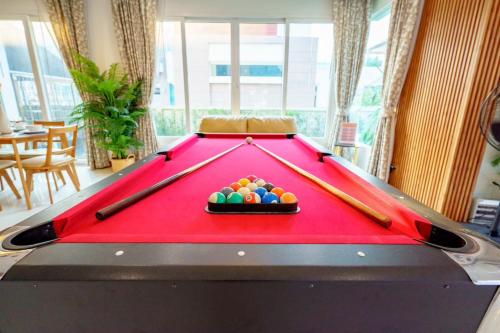 a pool table with billiard balls on top of it at Cozy beachside pool villa in Ban Rong Po