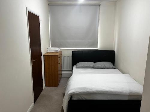 a small bedroom with a bed and a window at Budget Stay In Luton 02 03 in Luton