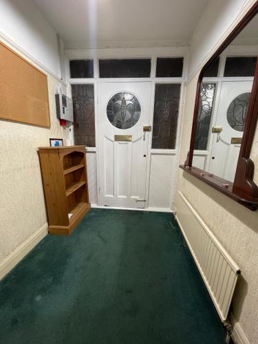 a room with a green floor and a white door at Budget Stay In Luton 02 03 in Luton