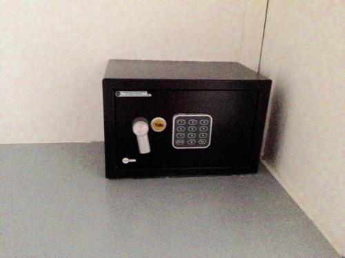a small black microwave sitting on a wall at Cita del Sol City Apartments in Cabarete