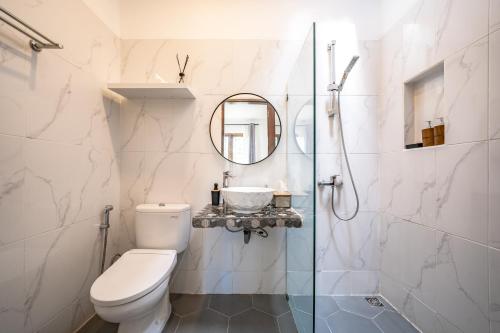 a bathroom with a toilet and a glass shower at Emerald Pura 2BR Villa - Private & Peaceful in Ungasan