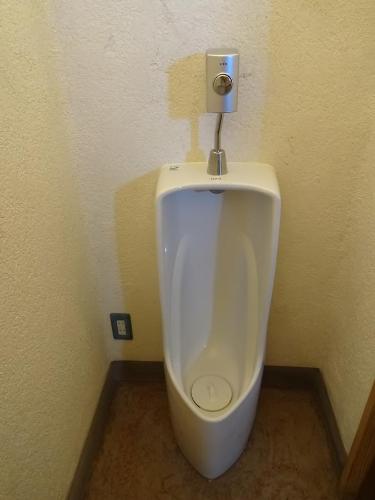 a bathroom with a urinal in a bathroom stall at Twin Dome Ryugu in Hokuto