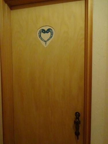 a door with a heart sticker on it at Twin Dome Ryugu in Hokuto