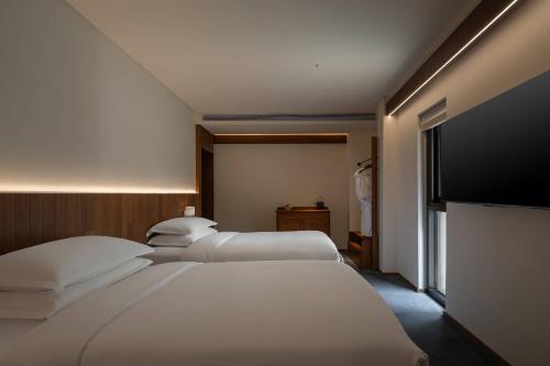 Una cama o camas en una habitación de Huanghsan SU House