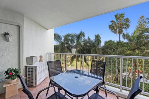 a patio with a table and chairs on a balcony at Crystal Bay On The Broadwater in Gold Coast