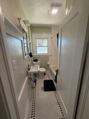 a small bathroom with a sink and a toilet at Brick Bungalow 1 block to I80 charmingly renovated in Reno