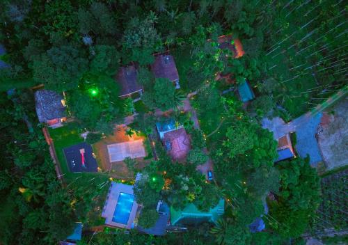an overhead view of a large house with trees and lights at Kedara Resort Wayanad by VOYE HOMES in Sultan Bathery