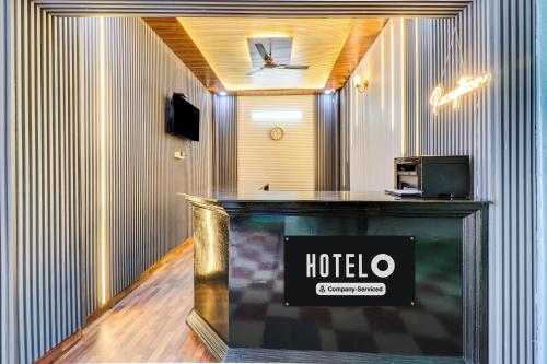 a hotel room with a sign on a counter at Super Hotel O Dehradun Central Railway Junction Formerly Bhagwan Guest House in Dehradun