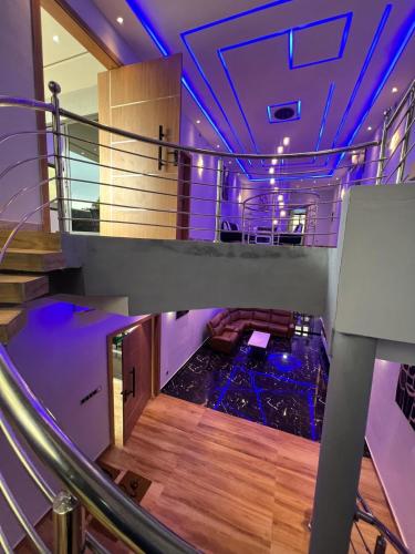 a room with a staircase with purple lighting at Villa moderne, luxueuse et sécurisée 